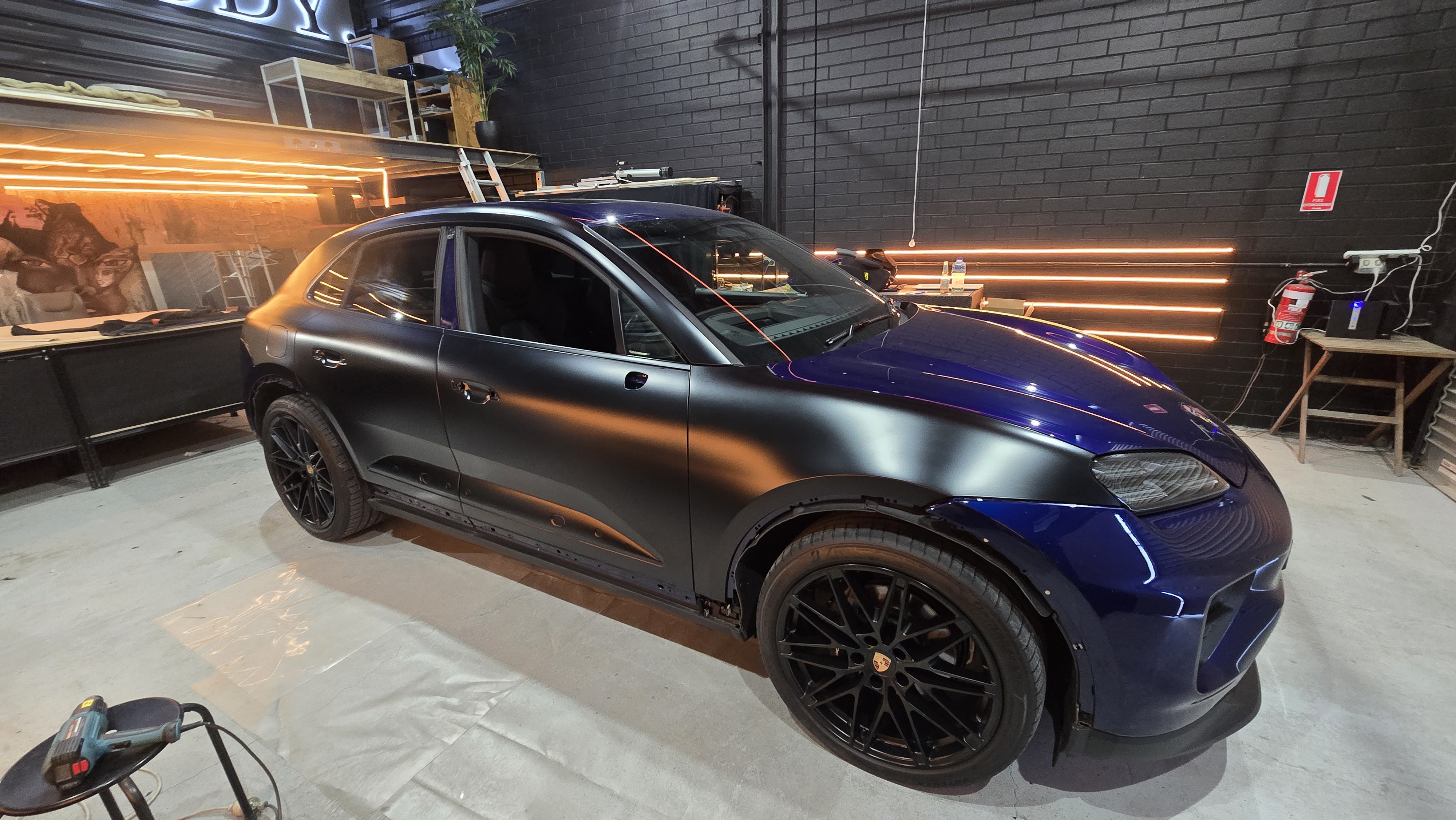 Porsche Macan mid-wrap in Wrapsody studio