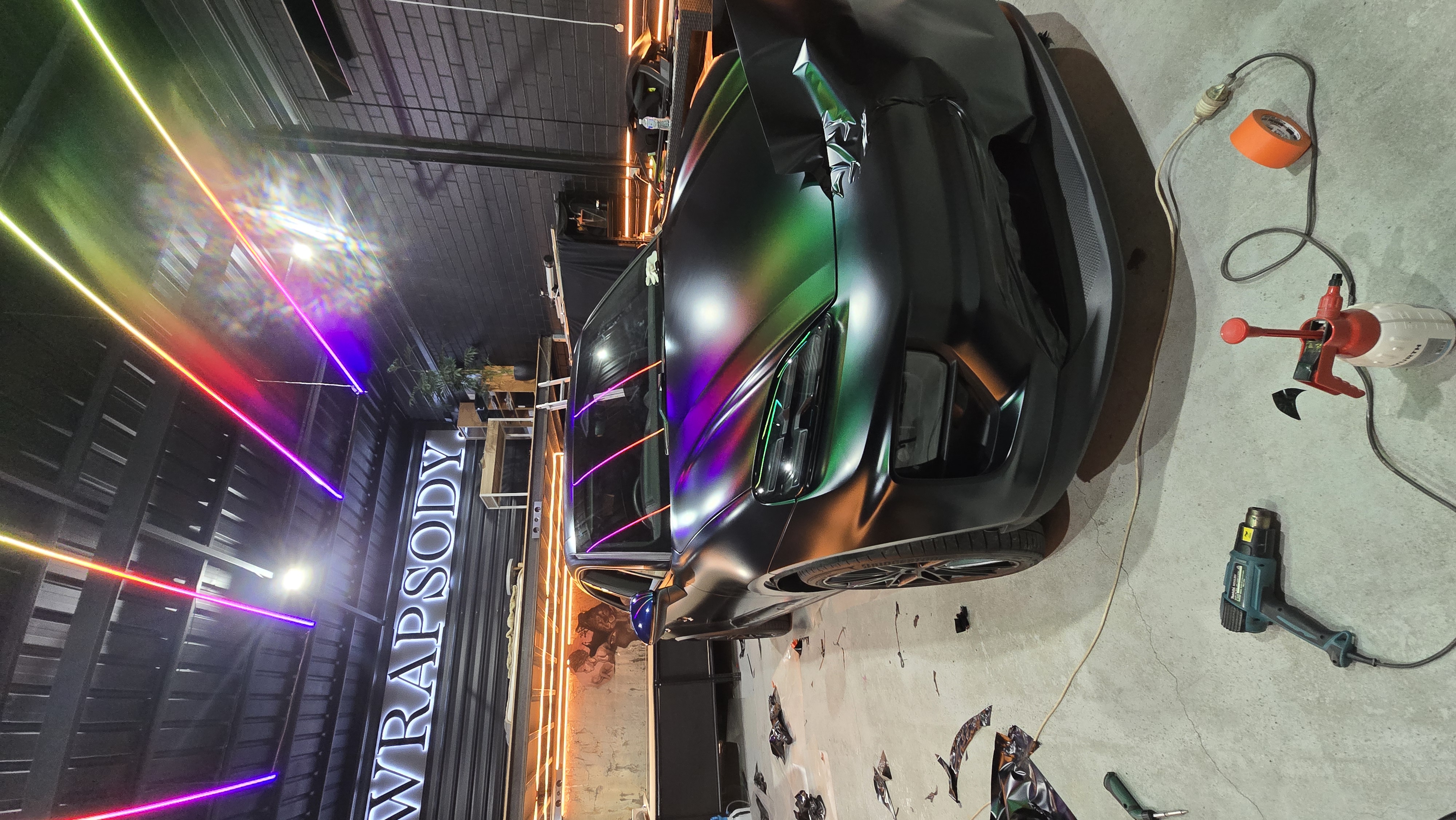 Iridescent wrap with neon reflections in studio
