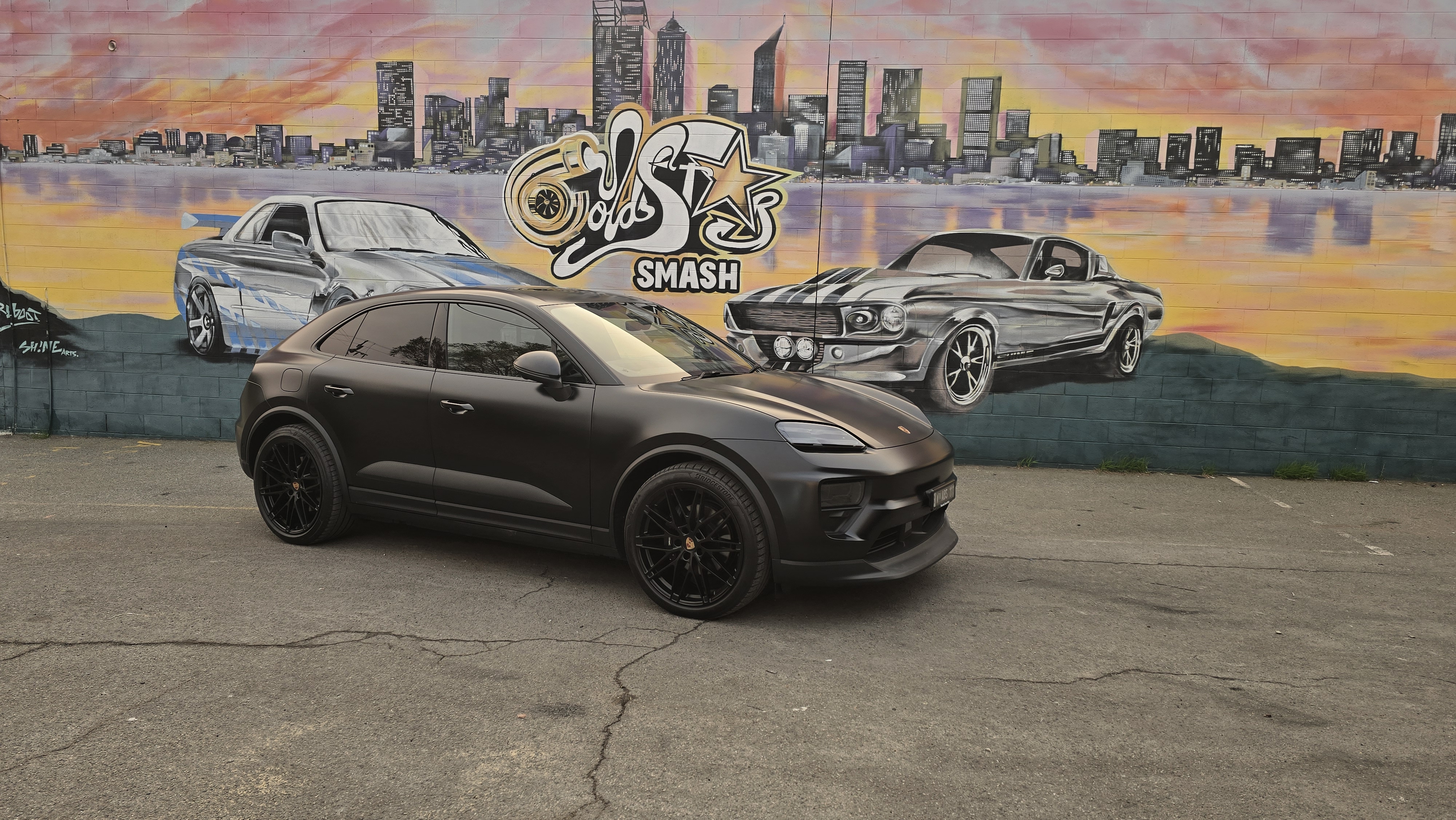 Porsche Macan matte black wrap at Goldstar mural
